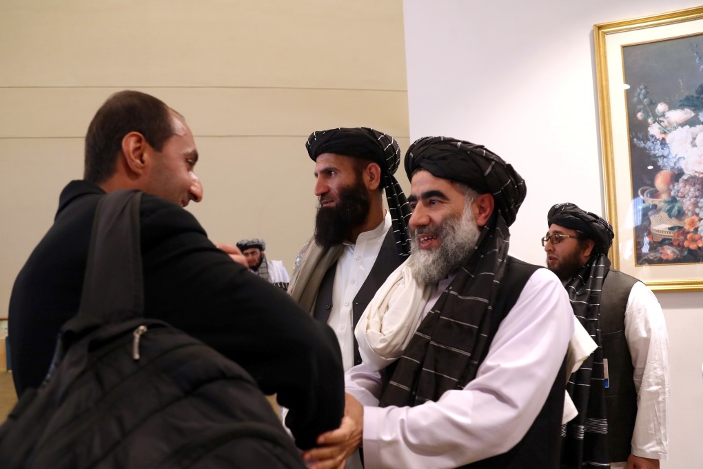 Members of Afghanistan's Taliban delegation gather ahead of an agreement signing in Doha. Photo: Reuters