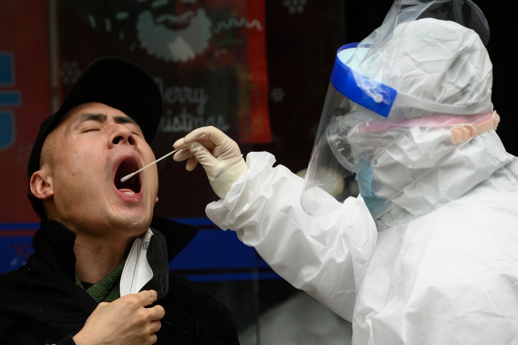 A man gets a swab test at a health clinic in Wuhan. China is now focused on containing imported cases. Photo: AFP