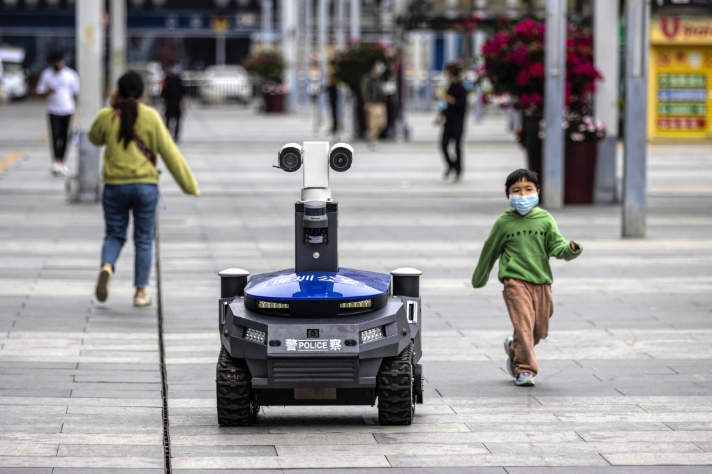A police security robot patrols near the high-speed railway station in Shenzhen on March 6. It can warn people if they are not wearing masks, and check their body temperature and identity. Photo: EPA-EFE
