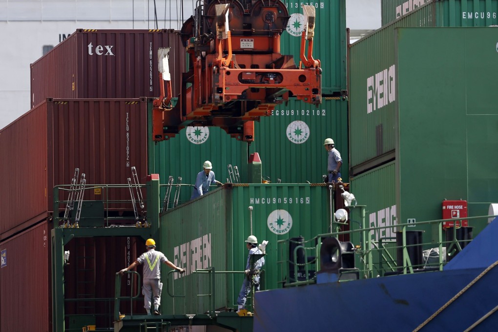 Crew watch as a container is loaded on to a cargo ship in Tokyo. The International Chamber of Shipping estimates that at least 100,000 seafarers a month need to change over from the ships they work on. Photo: Reuters