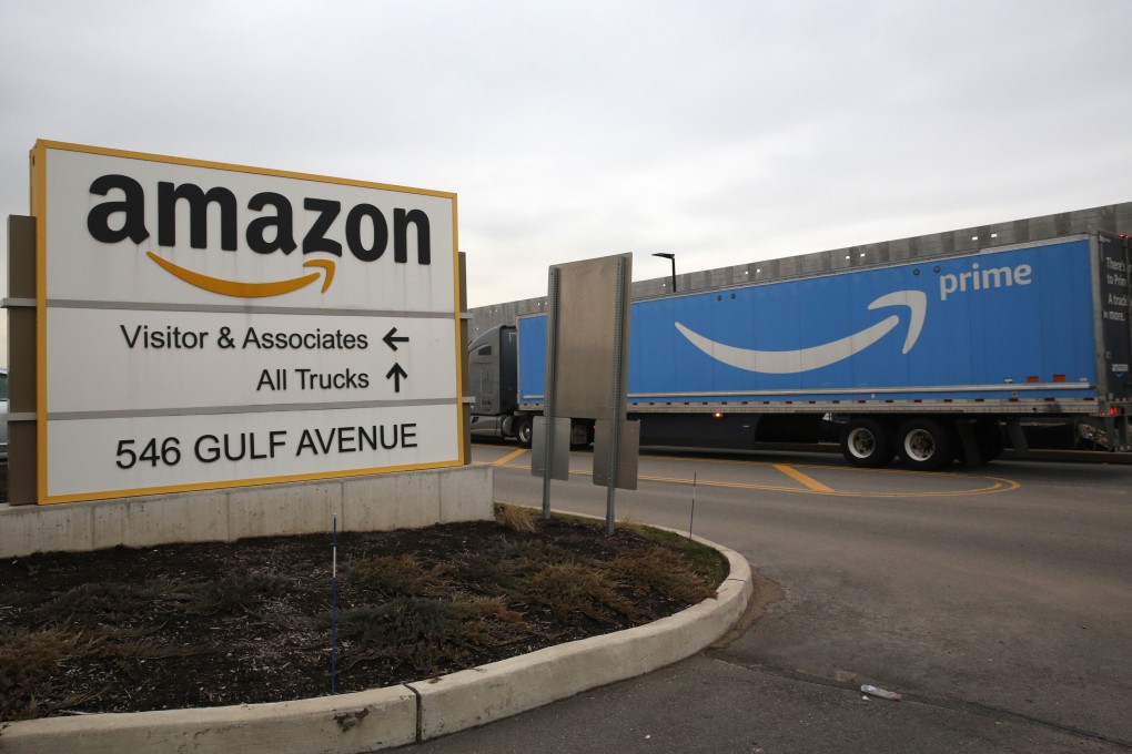 An Amazon Prime truck passes by the sign outisde an Amazon fulfillment center, Thursday, March 19, 2020, in Staten Island, New York. Photo: AP