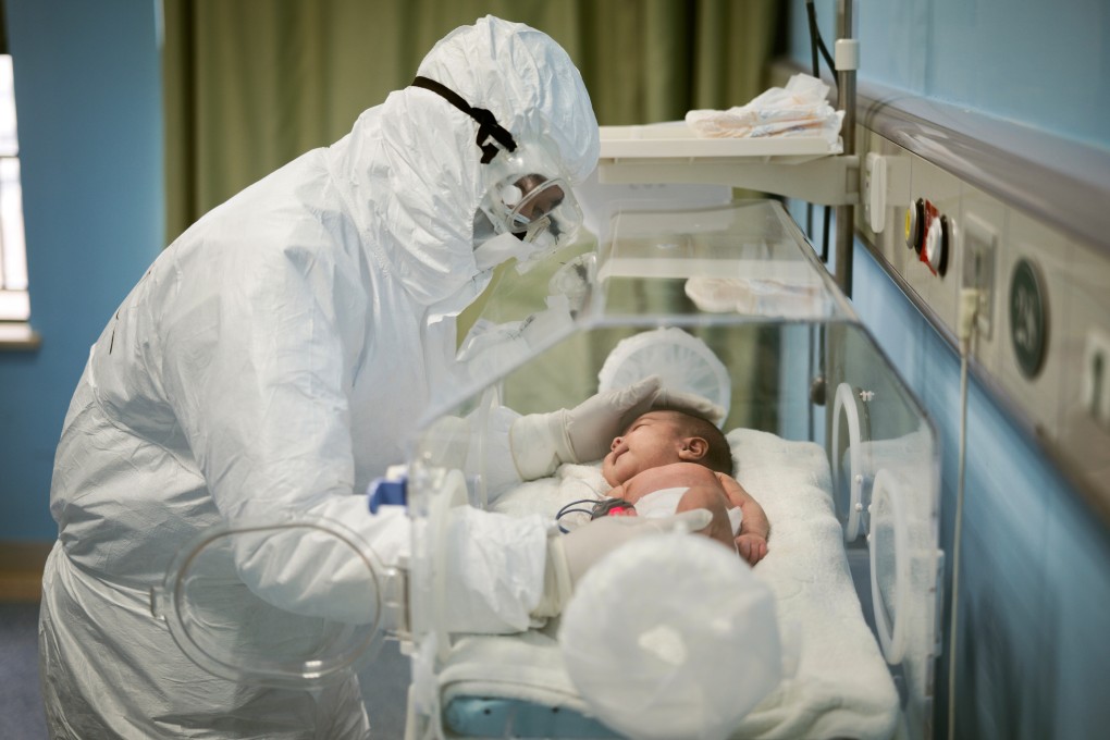 A Wuhan Children’s Hospital staff member attends to a baby infected with the coronavirusMARCH 6. Photo: Reuters