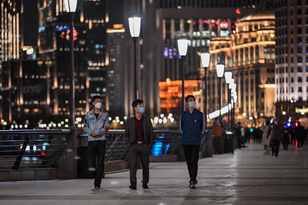 People wearing face masks amid concerns over the coronavirus outbreak walk along the promenade of the Bund in Shanghai. Photo: Agence France-Presse