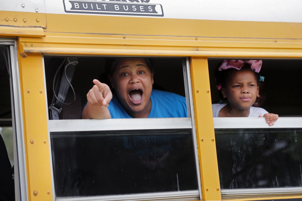 A congregant in a church bus yells out to news media as they leave services at the Life Tabernacle Church in Central. Photo: AP Photo