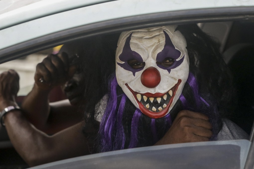 A passenger sits in a car wearing a mask, which he said was to prevent him catching the new coronavirus, in Lagos, Nigeria. Photo: AP