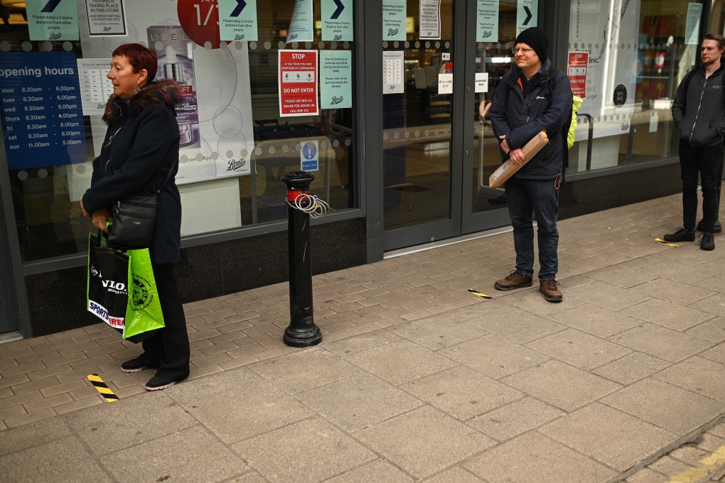 Shoppers in Britain practice social distancing. Photo: AFP