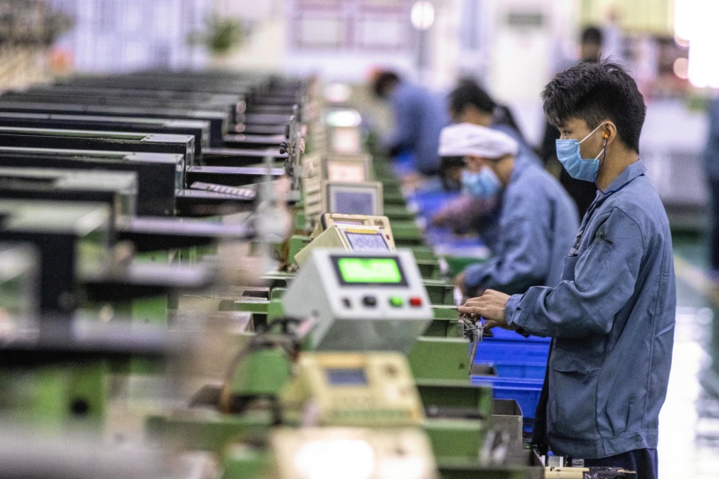 Workers wear protective face masks at a factory of home appliances company Galanz in Foshan, China, on February 18. China’s purchasing managers’ index bounced back strongly in March, up from an all-time low in February. Photo: EPA-EFE