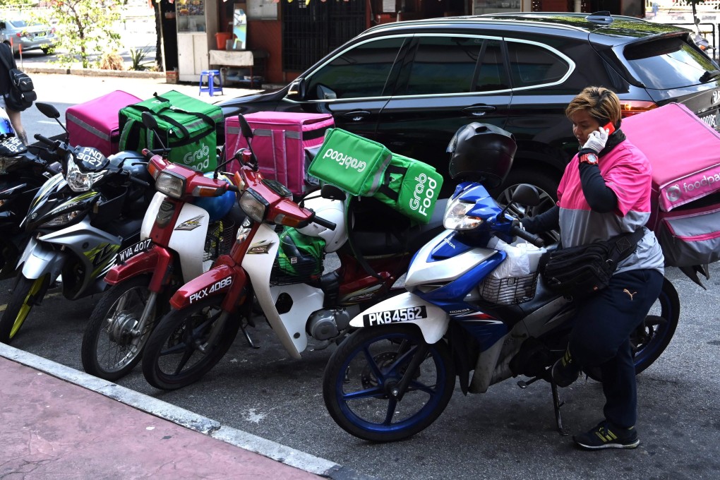A delivery rider in George Town prepares to deliver meals and groceries amid Malaysia’s lockdown. Photo: AFP