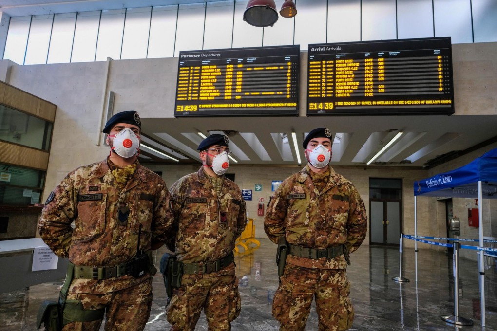 Italian soldiers stand guard and carry out checks at the Palermo's central station on Sicily island on March 20. Photo: EPA-EFE