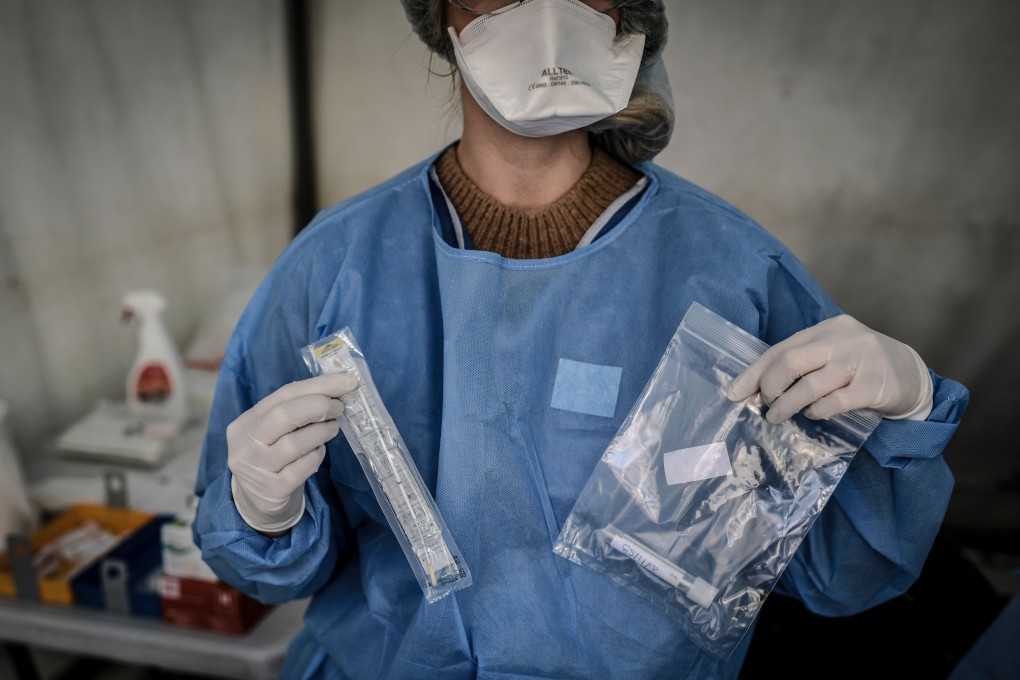 A nurse holds up a sample collected from a person at a Covid-19 screening station in Paris on Monday. Photo: AFP