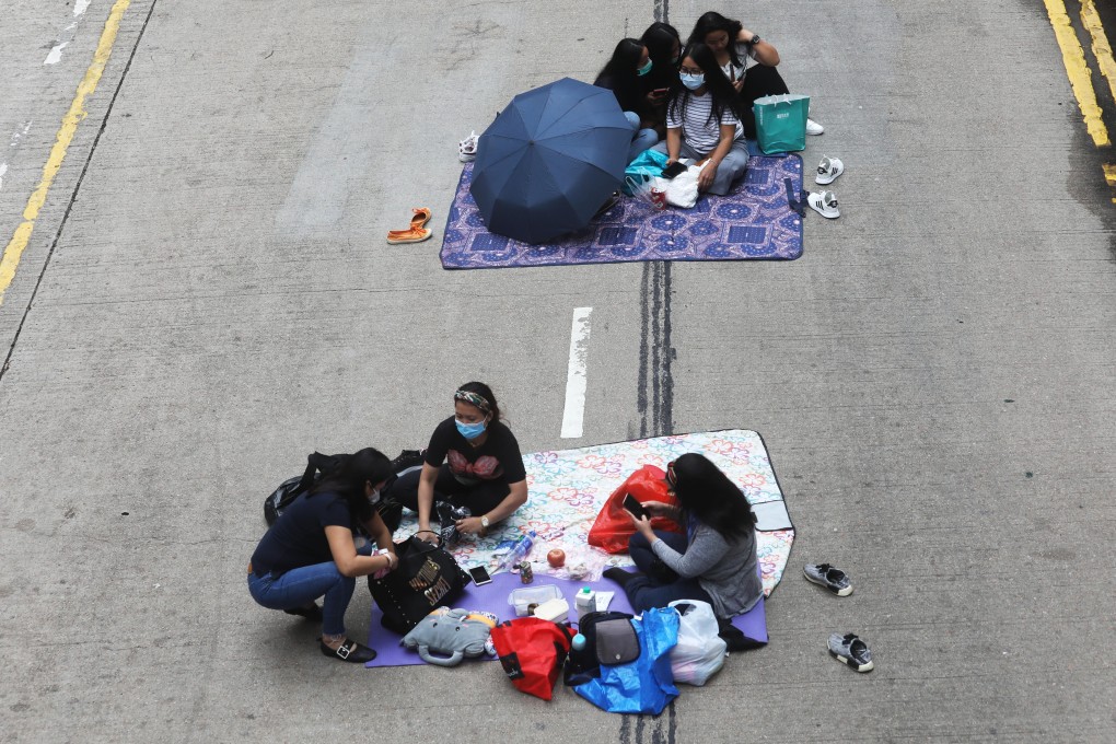 Domestic helpers try to meet social distancing norms while spending their day off, in Central on March 29. Photo: Dickson Lee