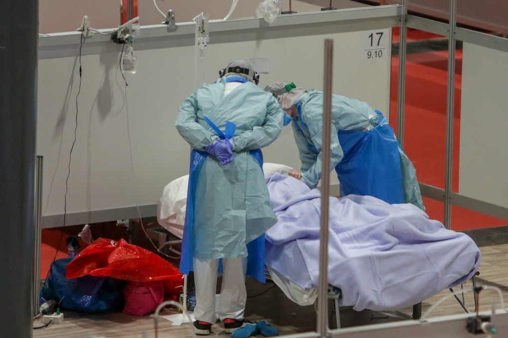 Medical workers attend a coronavirus patient at a temporary hospital set up at IFEMA event venue in Madrid. Photo: DPA