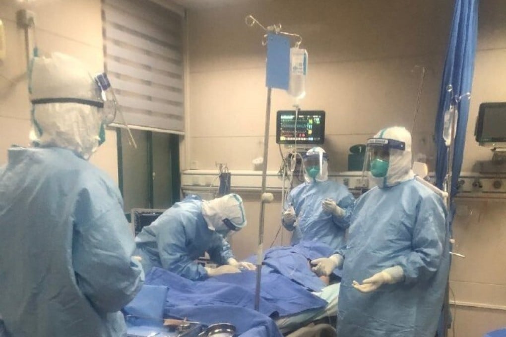 Intensive care doctors from Zhongnan Hospital in Wuhan treat a Covid-19 patient. Photo: Handout
