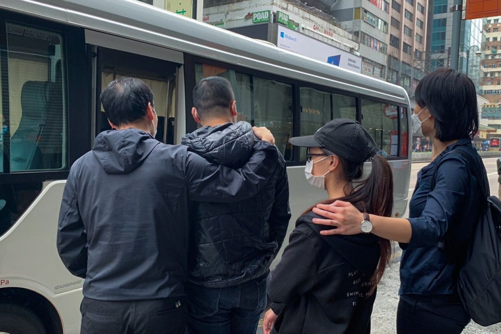 Suspected members of the gambling syndicate being led into a police van. Photo: Handout