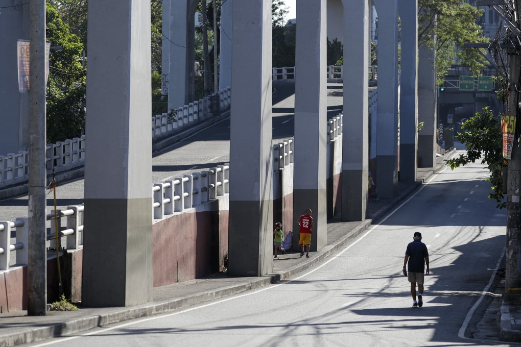 People exercise along a usually busy street during a community quarantine to help curb the spread of the new coronavirus in Manila. Photo: AP