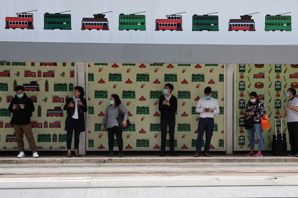People keep their distance while waiting for a tram in the Central district of Hong Kong. Photo: Nora Tam