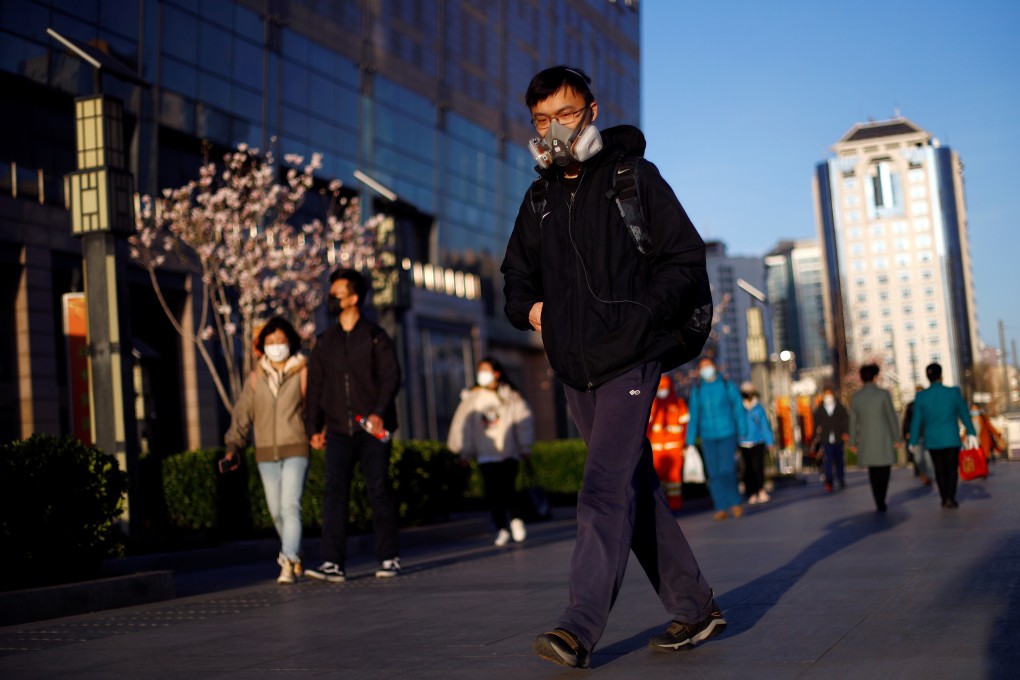 Commuters walk to a metro station in Beijing on March 27. Businesses in China are starting to revert to a normal work routine after weeks of strict quarantine measures but the economy is not yet out of the woods. Photo: Reuters