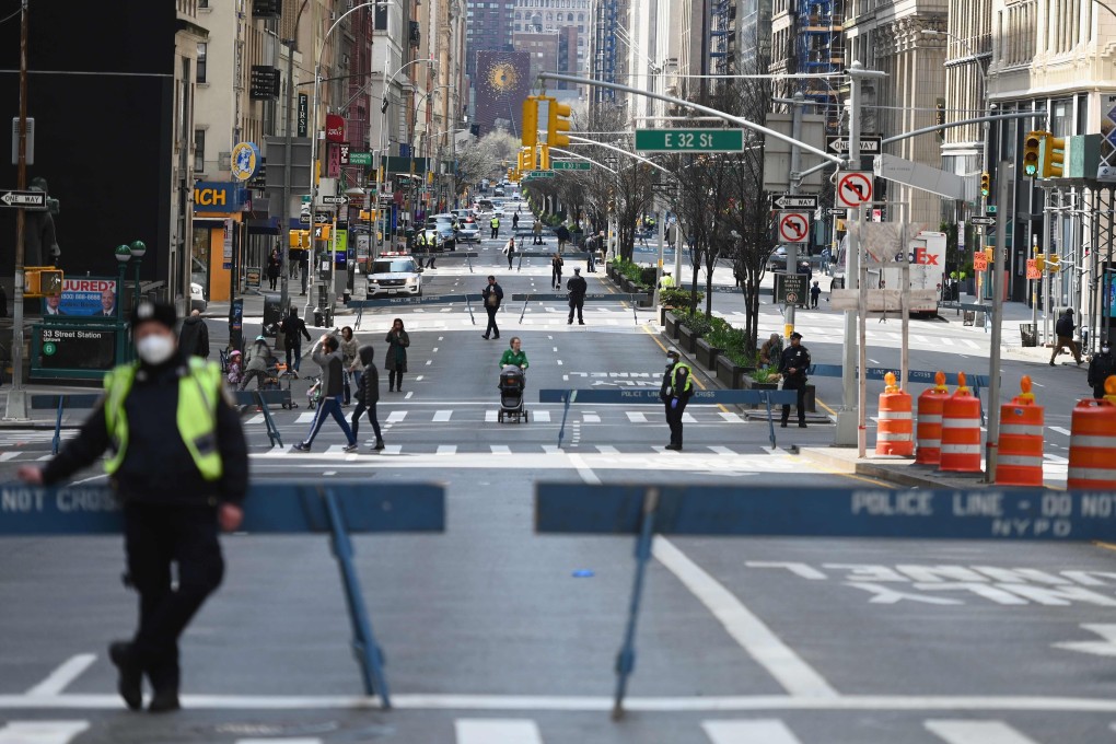 People are seen taking a walk and getting fresh air while social distancing on the closed of Park Avenue on March 27, 2020 in New York City. Photo: AFP