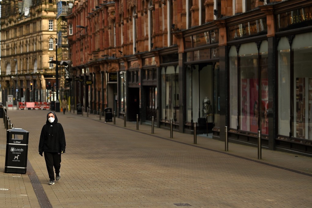 Closed shops on a near-empty street in the northern English city of Leeds on March 30, as the UK observes a three-week lockdown amid fears life may not return to normal for six months or longer. Photo: AFP