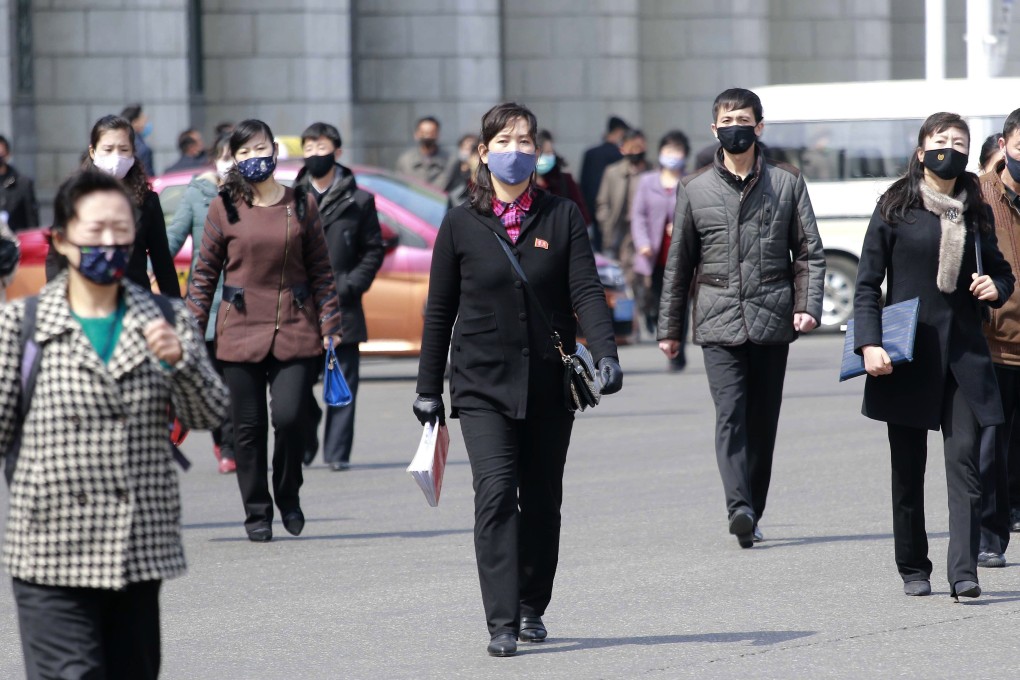 Pedestrians wear face masks in Pyongyang, as North Korea maintains that there are no coronavirus infections in the country yet. Photo: AP