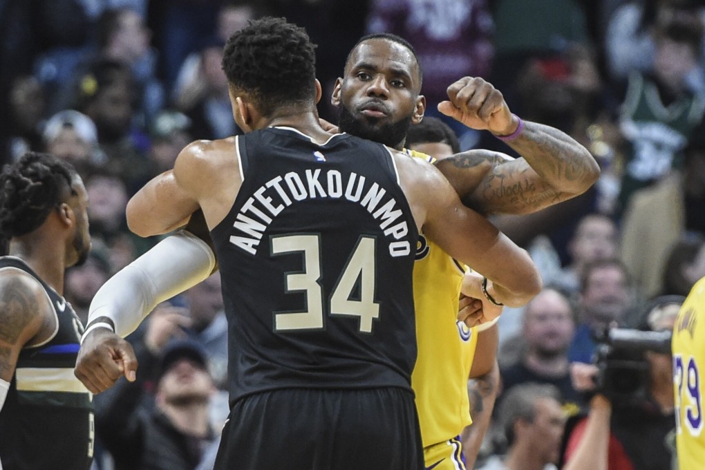 Milwaukee Bucks forward Giannis Antetokounmpo (34) gives Los Angeles Lakers forward LeBron James (23) a hug after an NBA game. Photo: USA Today