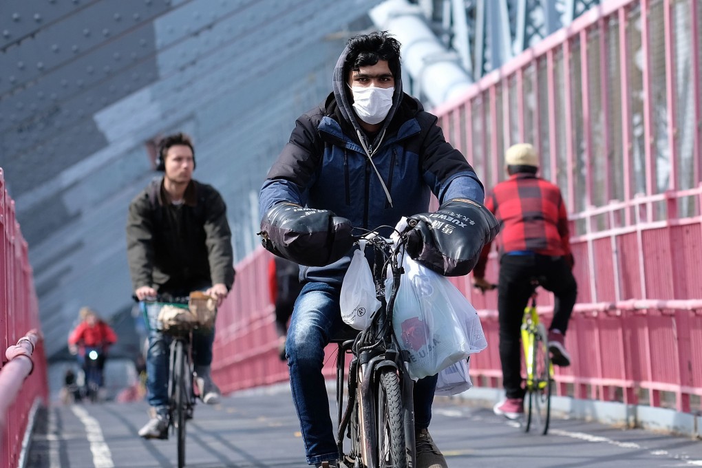A New York City cyclist wearing a mask on March 18. Photo: Getty Images/AFP