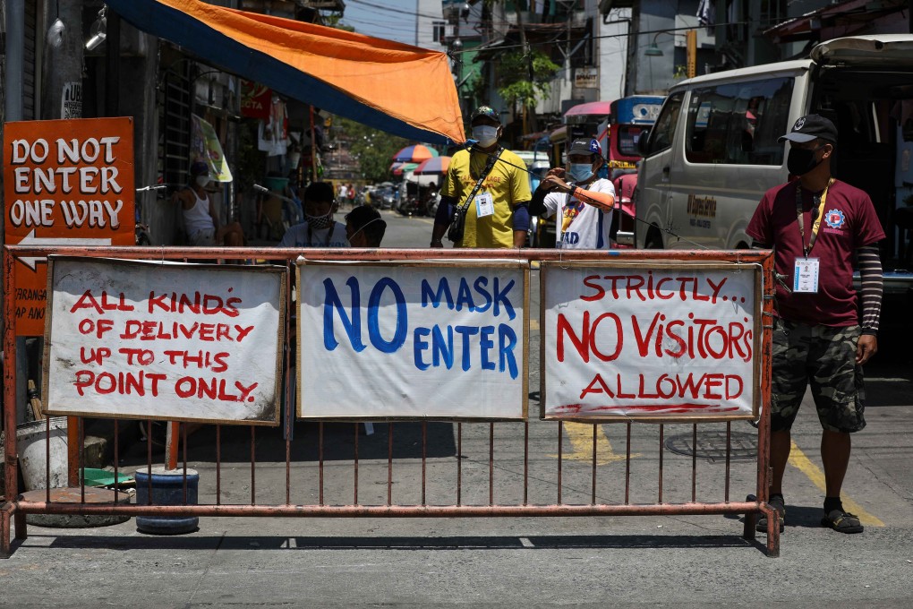 Local village volunteers stand guard at a checkpoint in Manila on April 3, 2020. Photo: EPA-EFE