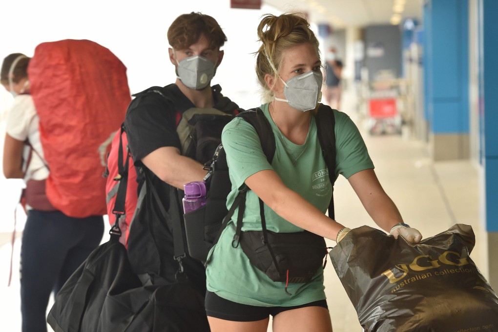 French nationals enter Sydney's international airport to be repatriated back to France on Thursday. Photo: AFP