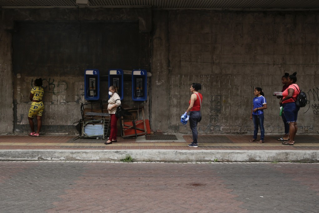 Women practice social distancing as they wait in line to enter a supermarket in Panama City. Photo: AP