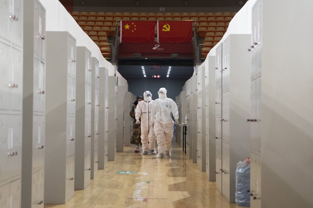 Medical staff carry out checks on patients at a makeshift hospital treating Covid-19 patients in Wuhan in February. Photo: EPA-EFE