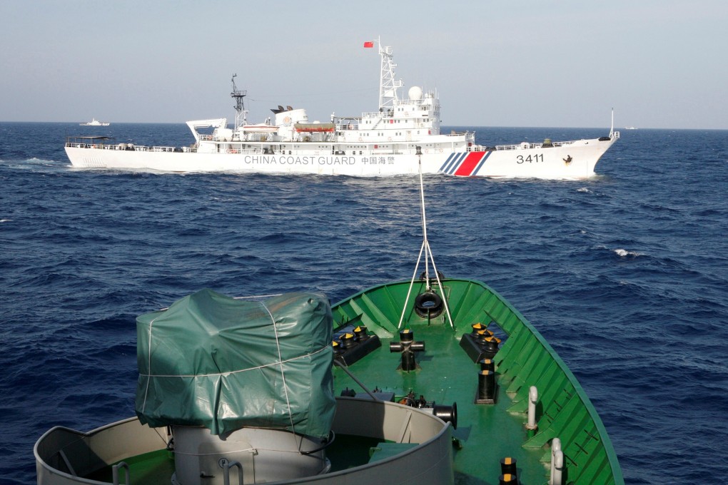 A Chinese Coast Guard ship is seen near a Vietnam Marine Guard ship in the South China Sea. Vietnam claims a Chinese vessel hit and sank a fishing boat near the Paracel Islands. Photo: Reuters