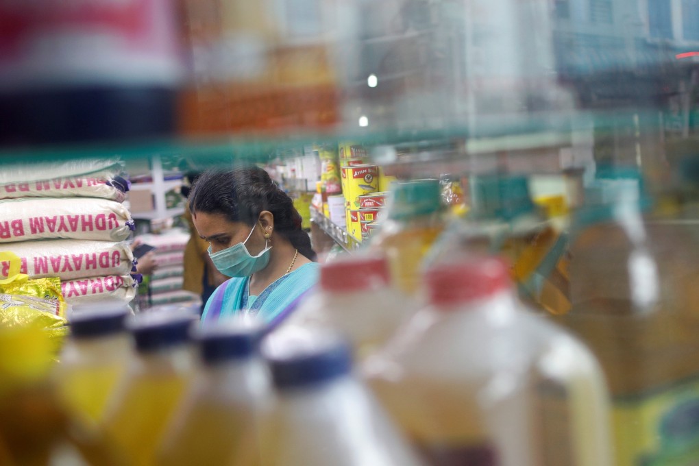 A woman wears a face mask in Singapore on Thursday, as the spread of Covid-19 continues. Photo: Reuters