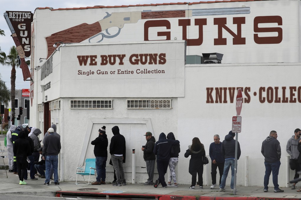 People wait in line outside to buy supplies at a US gun store. Photo: Reuters
