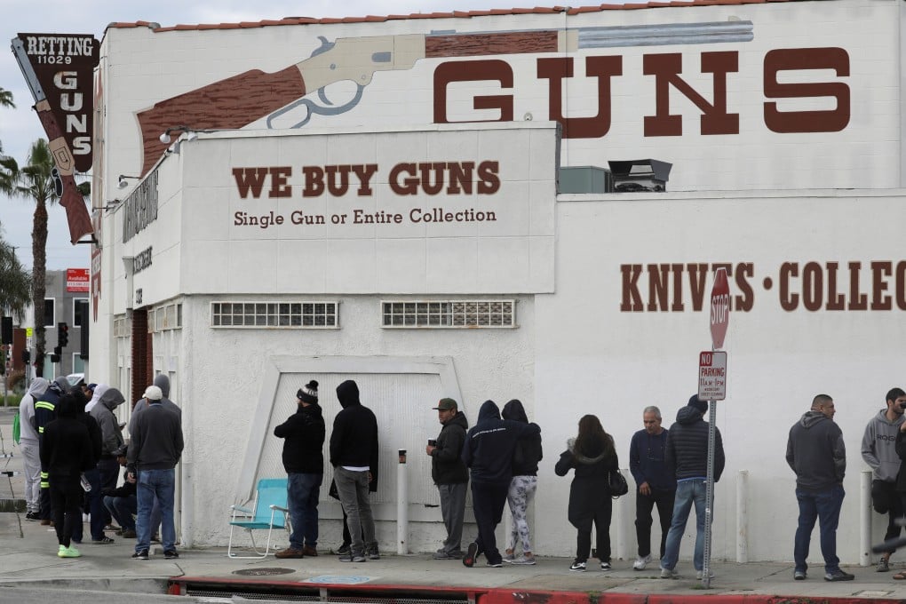 People wait in line outside to buy supplies at a US gun store. Photo: Reuters