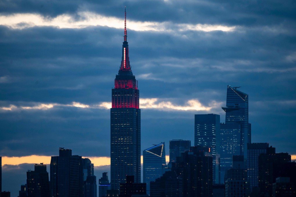 The Empire State Building is lit white and red to pay tribute to medical workers battling the coronavirus outbreak in New York City. Photo: AFP