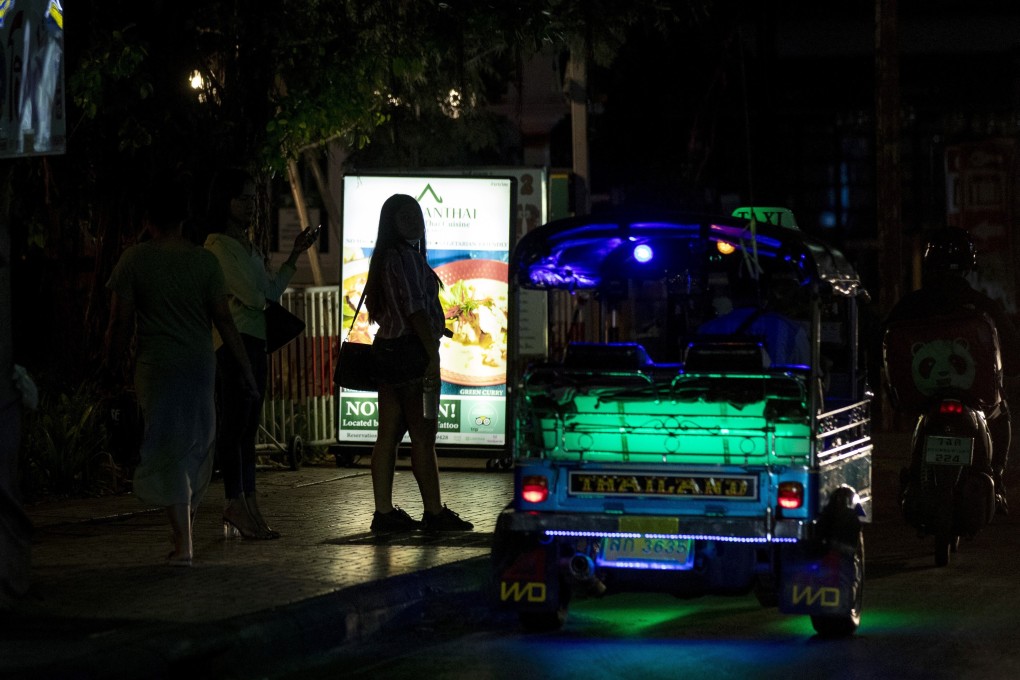 Sex workers in a largely shut-down red light area in Bangkok, Thailand on Thursday. Photo: AFP
