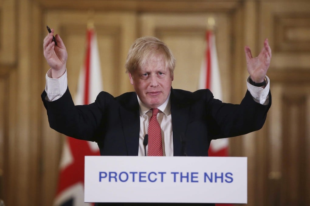British Prime Minister Boris Johnson gestures during a daily coronavirus press briefing at Downing Street in March. Photo: AP