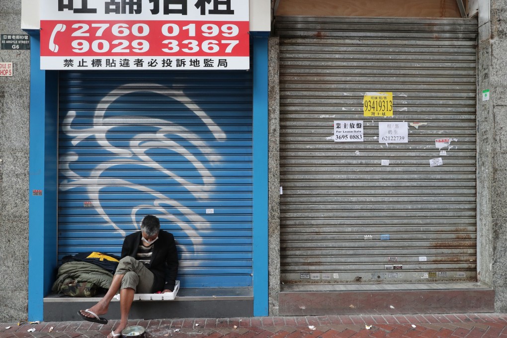 A homeless man sits in front of closed retail shops in Mong Kok on February 25, with Hong Kong in the grip of a Covid-19 outbreak. Photo: Edmond So