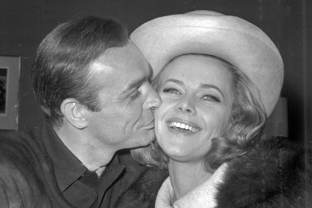 Actor Sean Connery kisses actress Honor Blackman during a party at Pinewood Film Studios in England in March 1964. Photo: AP