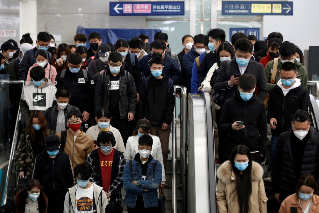 People wearing face masks crowd escalators inside a subway station during morning rush hour in Beijing, as workers across the country gradually return after weeks of lockdown and stay-at-home orders. Photo: Reuters