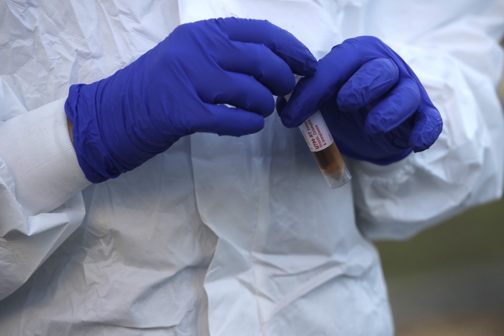 A medical worker takes samples at a Covid-19 drive-through testing station in Rome on Friday. Photo: AP