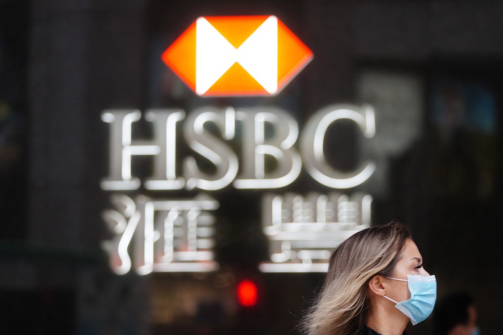 People walk past the HSBC logo in Central. The bank followed the call from the Prudential Regulation Authority, a British regulator, to cancel dividends until at least the fourth quarter in the light of the coronavirus pandemic. Photo: Sam Tsang