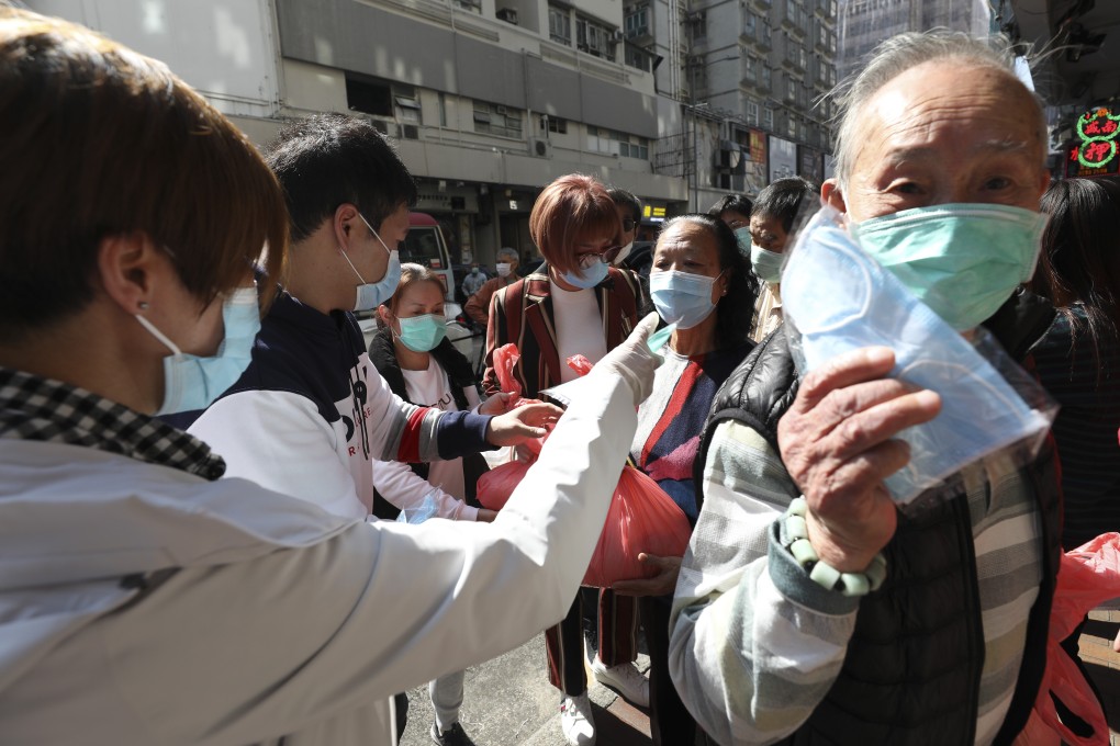 Hundreds queue in Sham Shui Po for free rice and surgical masks in February 2020, as Hong Kong grappled with shortages amid a coronavirus outbreak. The work of NGOs, charities and other social enterprises is more important than ever in a city in crisis, but many are facing bankruptcy. Photo: Nora Tam