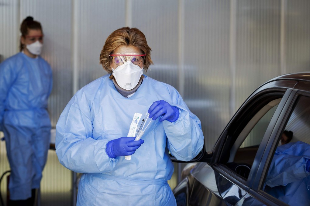 A medical worker holds a test kit at a screening centre in Amsterdam, the Netherlands. Photo: AFP