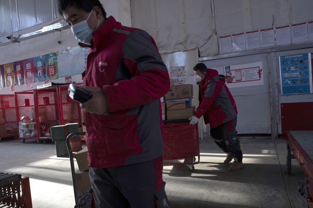 In this photo dated Feb. 18, 2020, delivery workers for Chinese e-commerce giant JD.com prepare for the morning round of deliveries from a distribution center in Beijing. Photo: AP