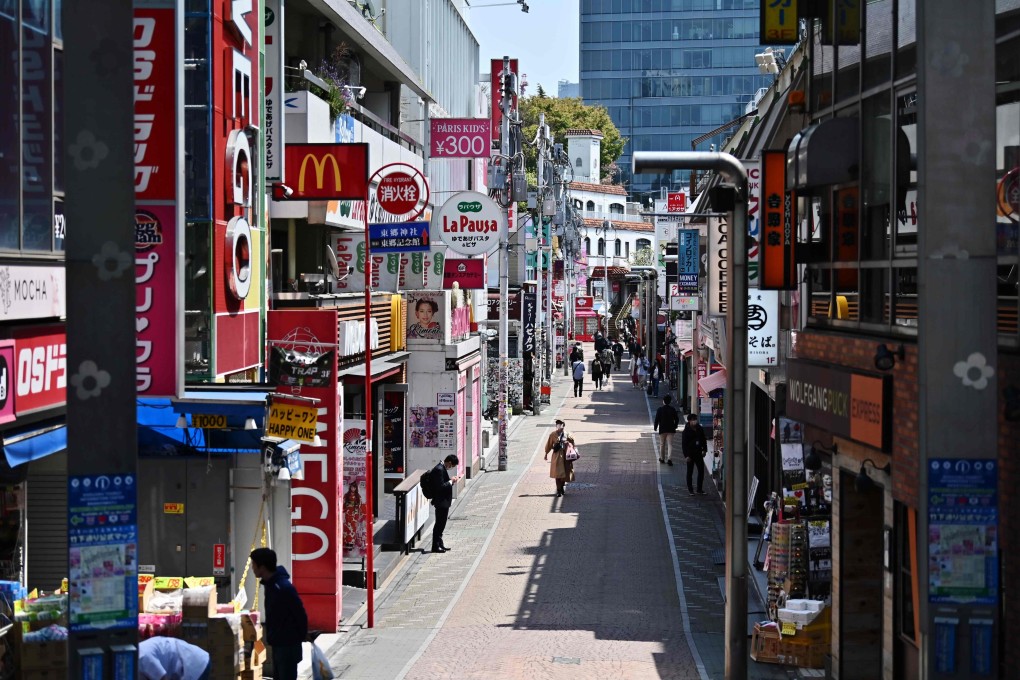 A handful of people walk on the usually busy Takeshita street in Tokyo's Harajuku district on Wednesday. Photo: AFP