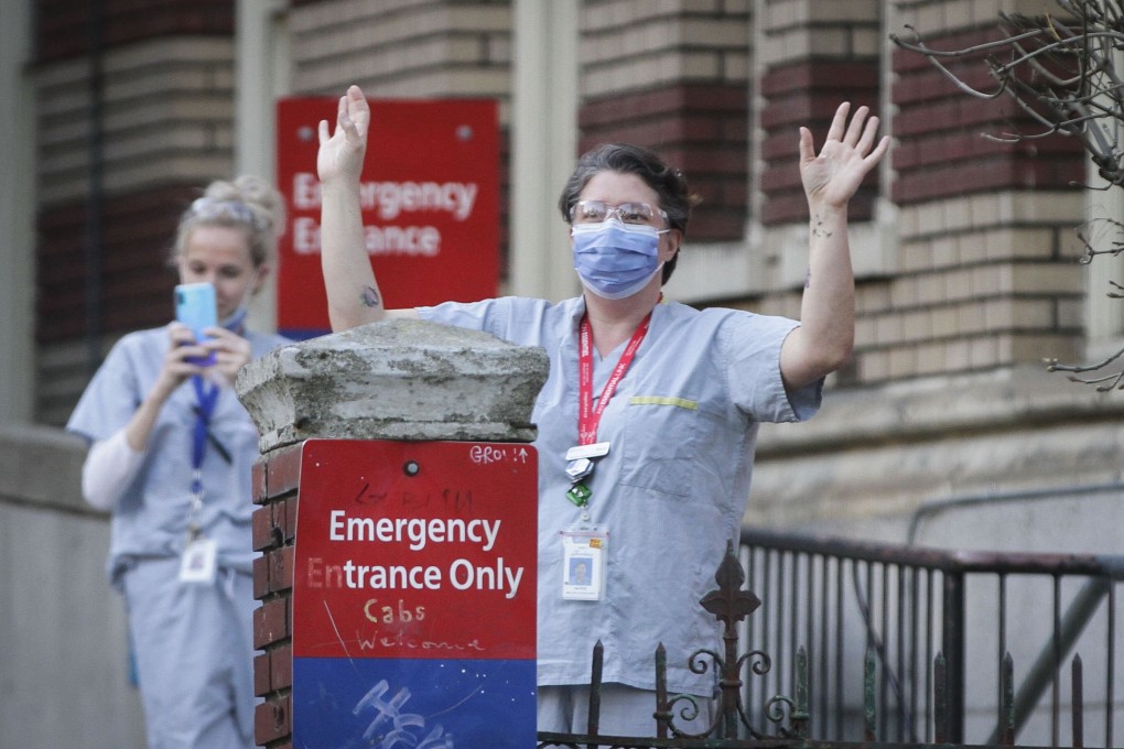 Health care workers acknowledge applause from people outside St Paul’s Hospital in Vancouver on Monday. Photo: Xinhua