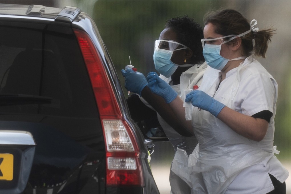 Medical workers at an NHS drive through coronavirus disease testing facility in London, Britain, March 29, 2020. Photo: EPA-EFE