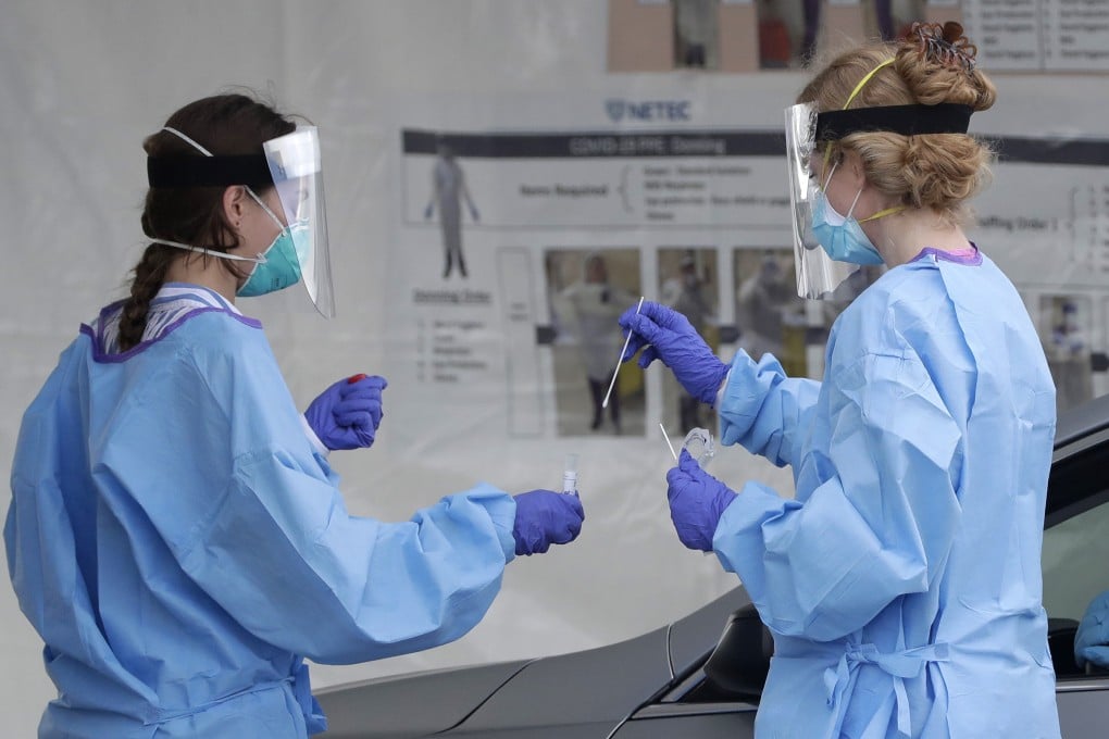 Health care workers handle coronavirus testing kits on Wednesday in Miami, Florida. Photo: AP