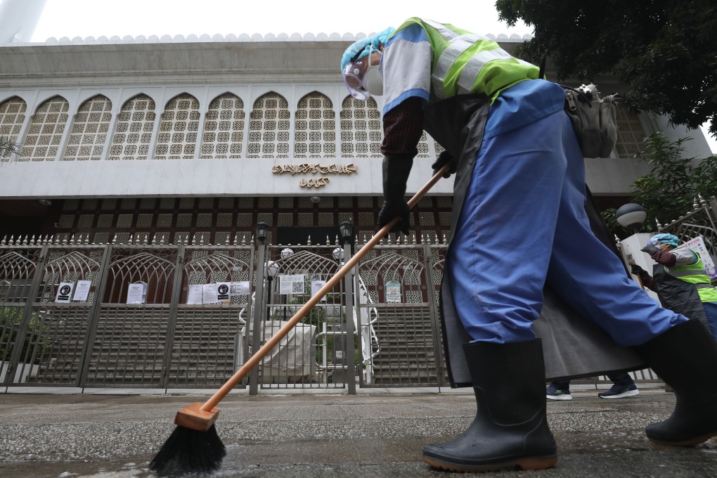 Workers use cleaning bleach at the front gate of the Kowloon Mosque and Islamic Centre in Tsim Sha Tsui after a coronavirus diagnosis of a man who had visited the mosque. Photo: Nora Tam